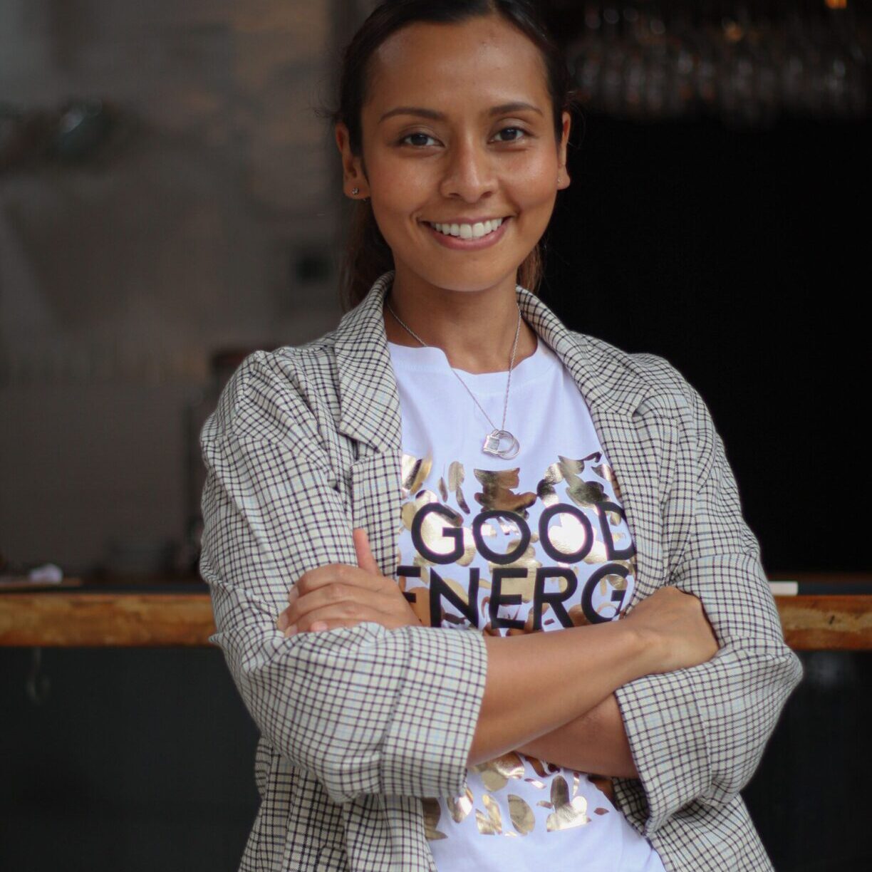 A woman standing with her arms crossed.