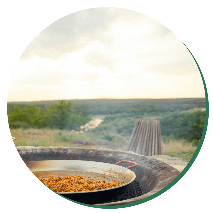 A pan of food on top of an outdoor grill.